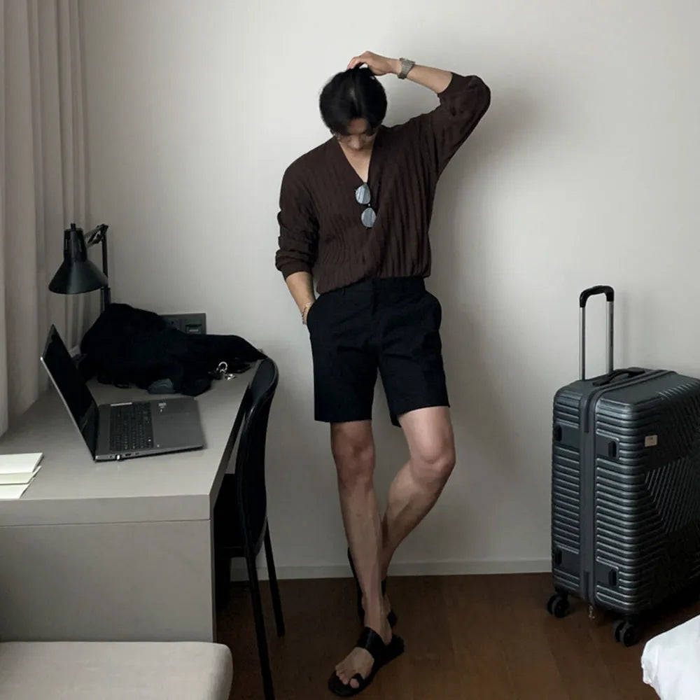 Men's loose straight leg shorts in solid black colour made from polyester fabric