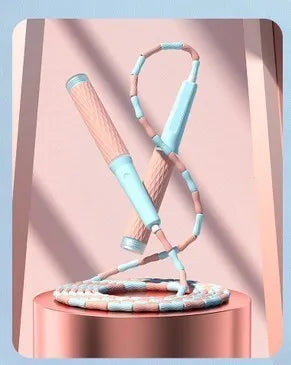 A children's skipping rope with soft bamboo-style beads, shown in a choice of blue, pink, green, and purple colours.