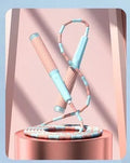 A children's skipping rope with soft bamboo-style beads, shown in a choice of blue, pink, green, and purple colours.
