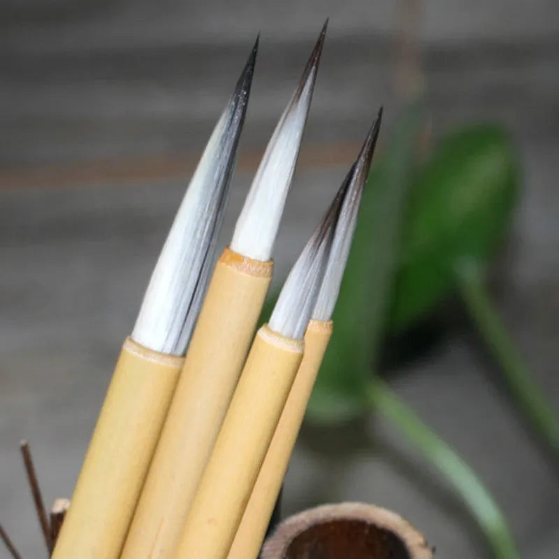 Set of four gold body writing brushes with wolf hair bristles in pine branch colour