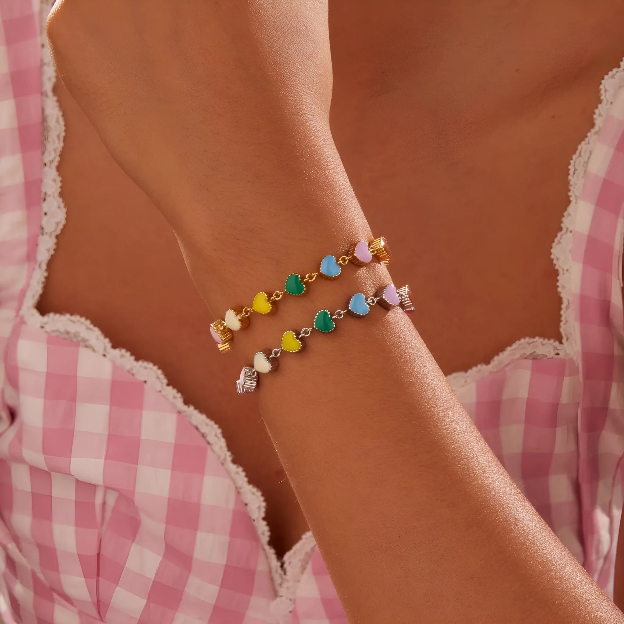 Gold and steel colour heart-shaped titanium steel bracelet on a model's wrist.