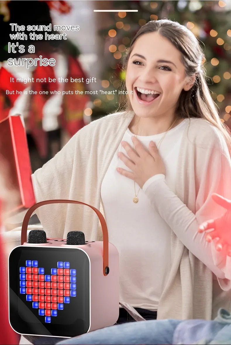 Portable Bluetooth karaoke speaker in black with two wireless microphones, 15W output, RGB rhythm light, and iron mesh front.