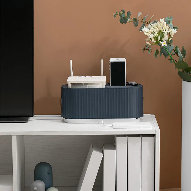 Blue and white power strip storage box with lid showing cable holes and internal phone slot
