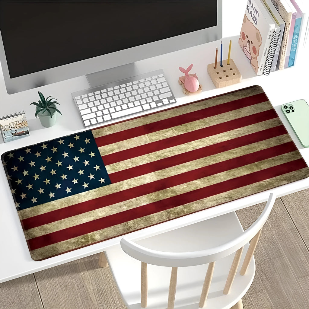 Large rectangular mouse pad with printed pattern lying flat on a wooden desk.