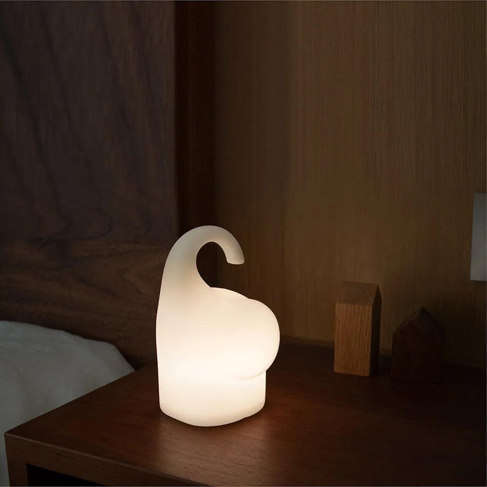 Elephant-shaped silicone night light with warm white LED glow, measuring 96mm wide by 151mm high