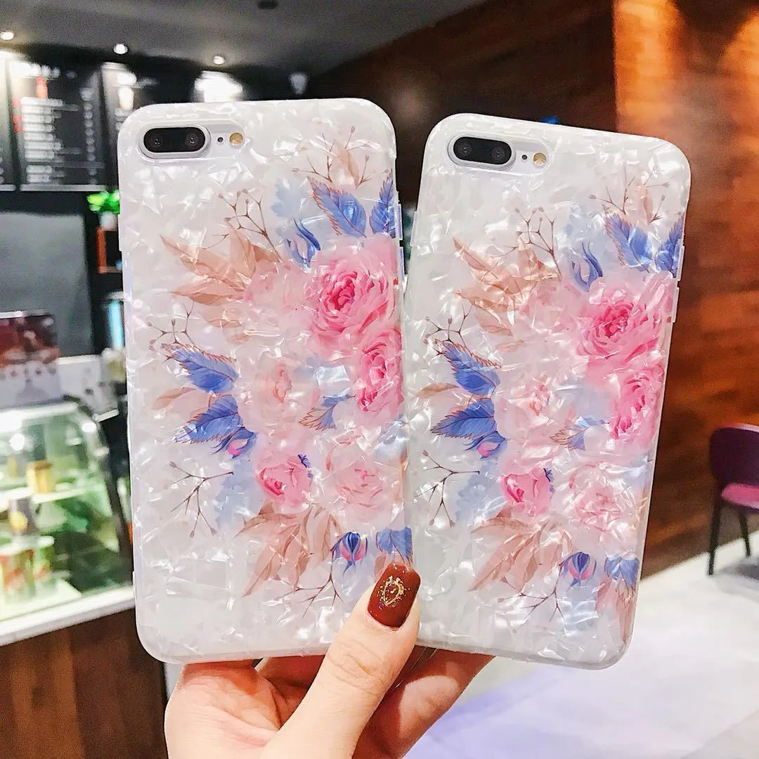 Soft TPU iPhone case with a rose flower design on the back, shown in brown.