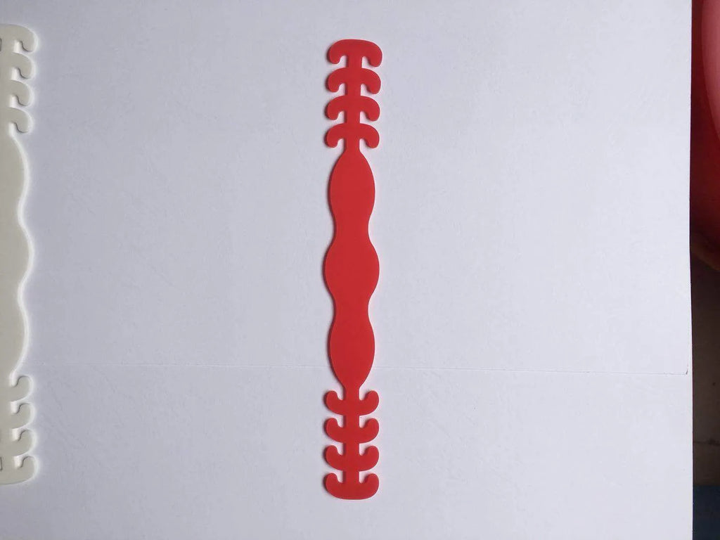 Set of eight small silicone tool buckles in various colours including red, yellow, black, and blue.