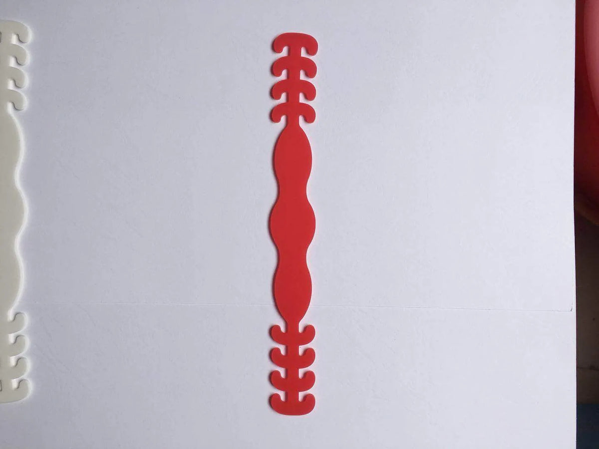 Set of eight small silicone tool buckles in various colours including red, yellow, black, and blue.