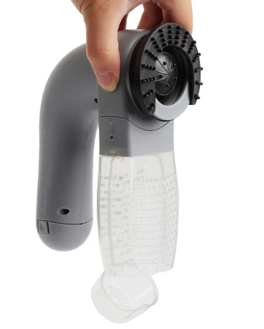 Grey portable pet hair vacuum cleaner and massage brush for dog and cat grooming on sofa