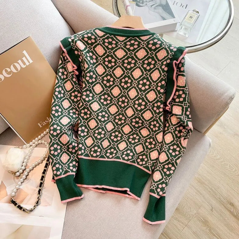 Green printed women's sweater with a loose fit and regular-length sleeves.