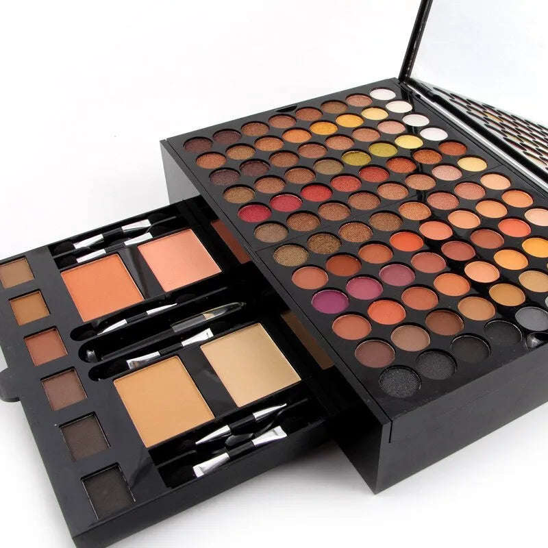 Piano-shaped makeup palette open to show 180 eyeshadow colours, blushes, powders and contour shades