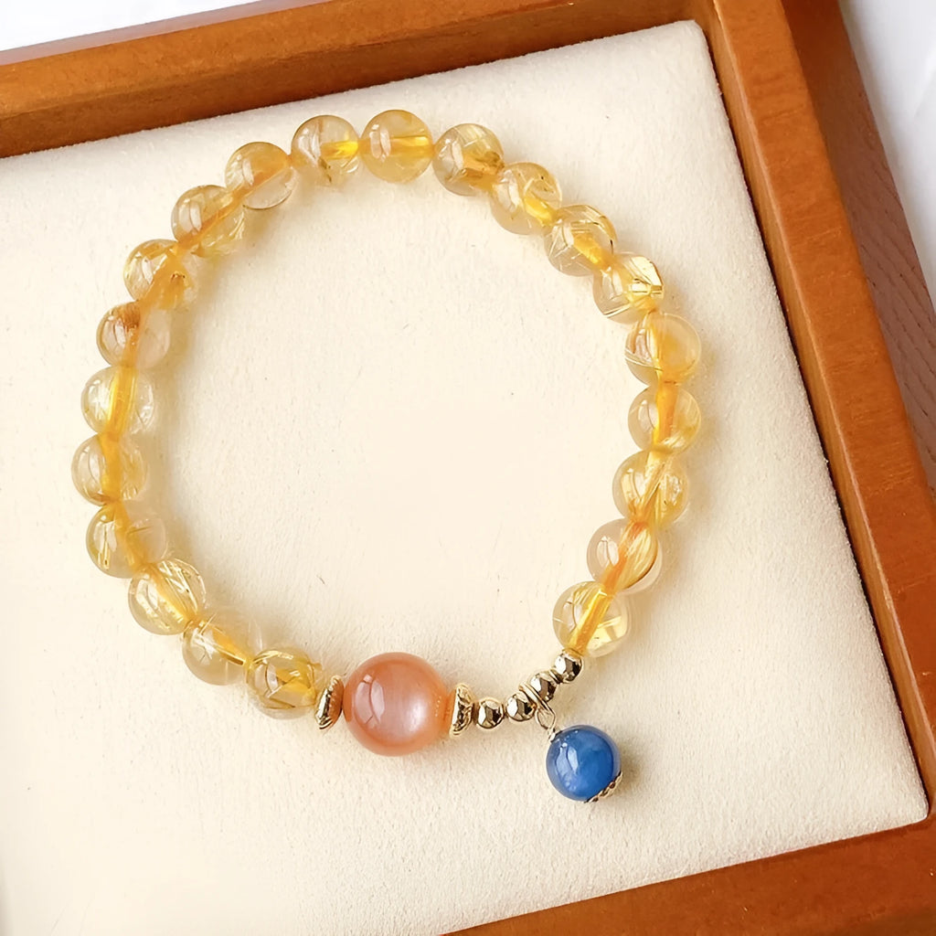 Women's gold rutilated quartz and sunstone crystal bracelet with round beads on elasticated band