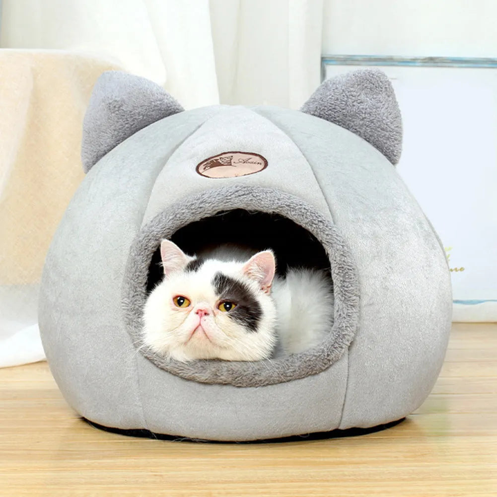 Large fully enclosed fabric cat house with a single entrance, shown in a home setting.