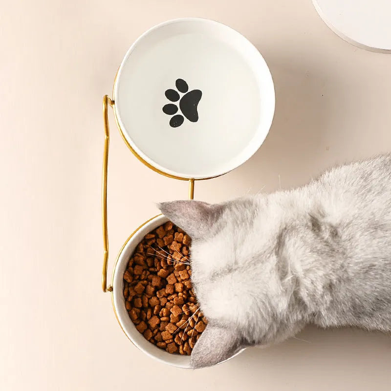 White ceramic cat bowl with cat footprints pattern on black iron frame