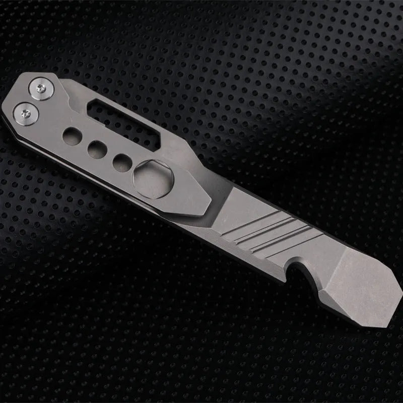 Titanium multi-function crowbar tool with screwdriver tip and bottle opener, shown in stone wash and gun grey finishes.