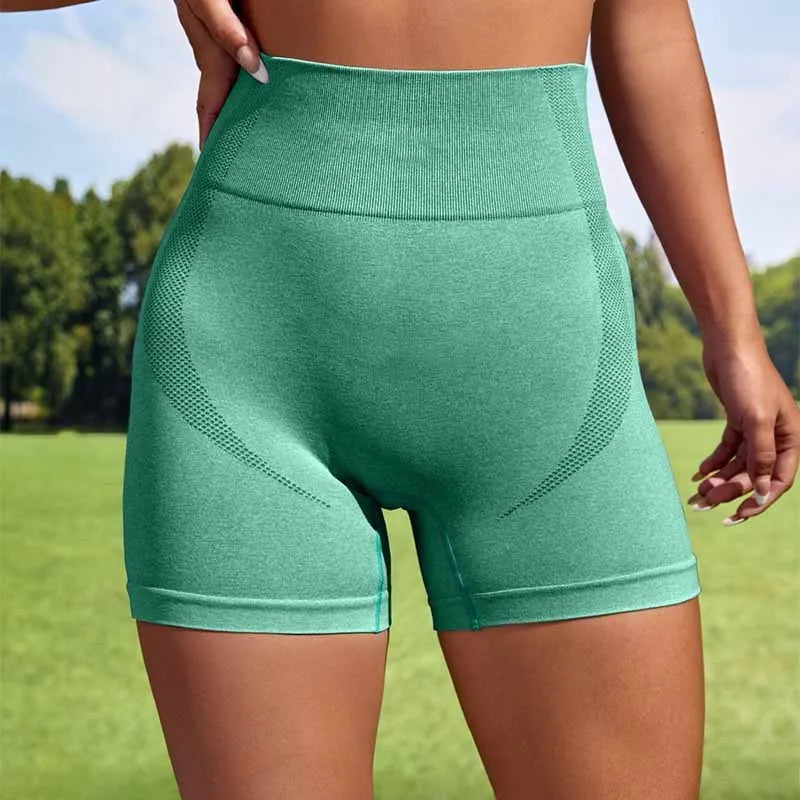 Women's seamless short leggings with high waist elastic in solid colour, showing moisture-wicking fabric for fitness activities