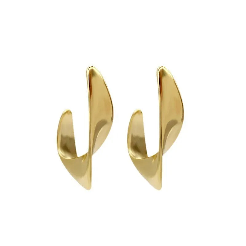 A pair of twisted geometric design metal earrings in gold or silver electroplated finish.