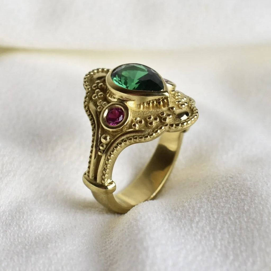 Gold-plated geometric fashion ring for women on grey background showing detailed design