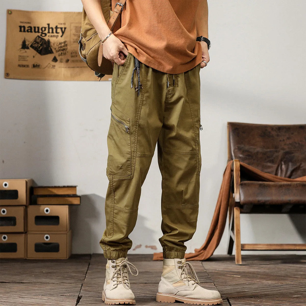Men's khaki harem pants with tapered legs and ankle bands, made from non-iron cotton fabric.