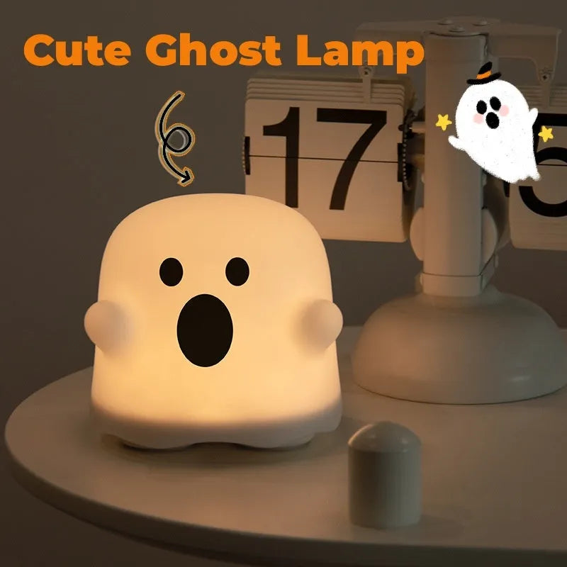 White silicone touch sensor LED night light on a bedside table.