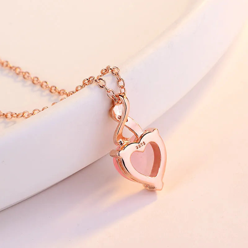 Women's heart-shaped pink crystal pendant necklace on rose gold cross chain