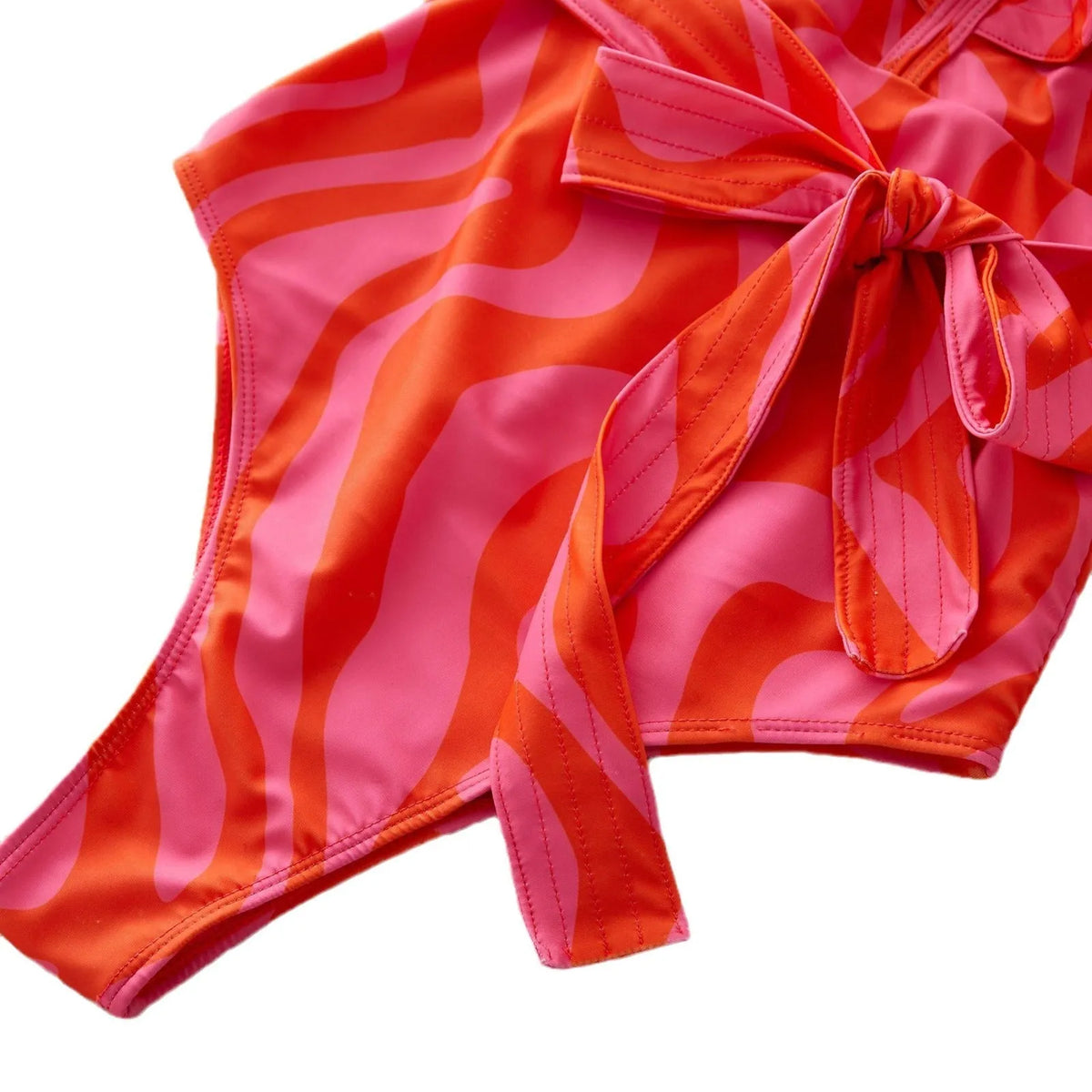 Women's deep V-neck one-piece swimsuit with mesh stitching and ruffled shoulders in a printing pattern.
