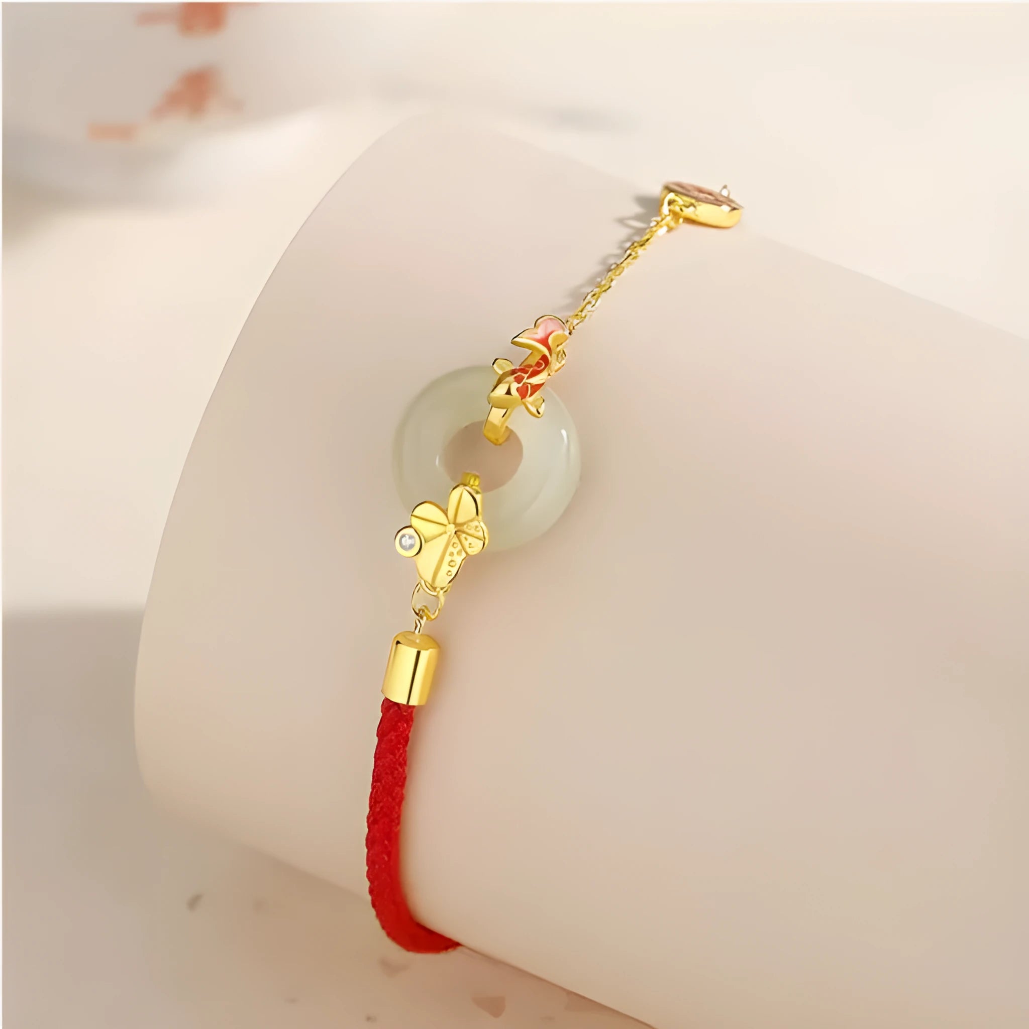 Gold electroplated 925 silver women's bracelet with koi and peace buckle design on adjustable red rope