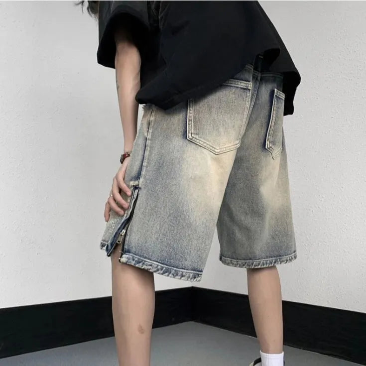 Blue retro tattered denim shorts with a wide leg loose fit on a neutral background.