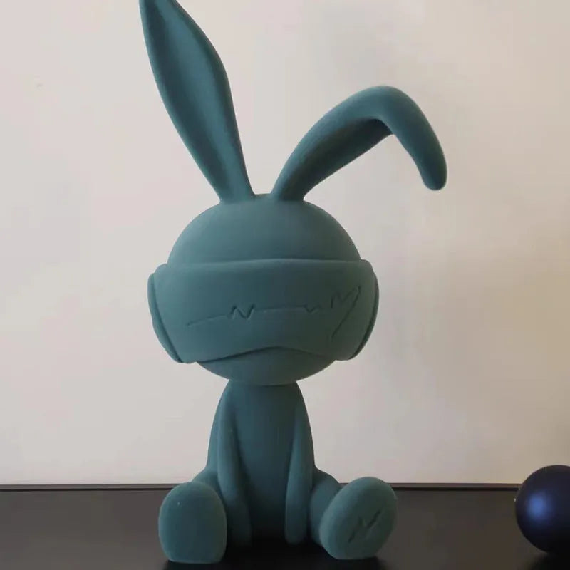 Green suede blindfold rabbit resin ornament on a wooden table, 15cm tall