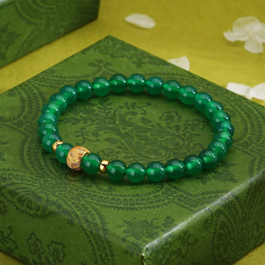 Green agate and sterling silver bracelet with yellow gold plating and a geometric bead.