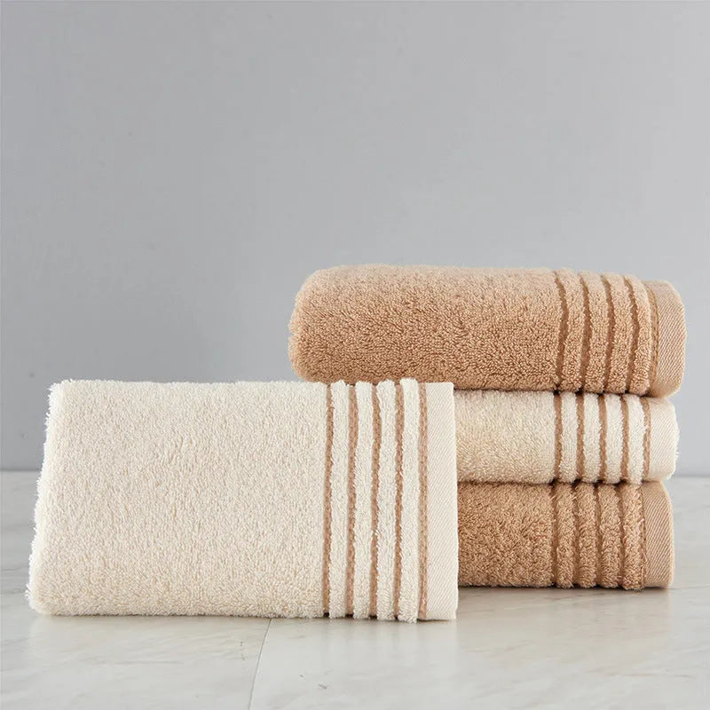 Cotton towel set in brown showing three sizes: large bath sheet, standard bath towel and small hand towel