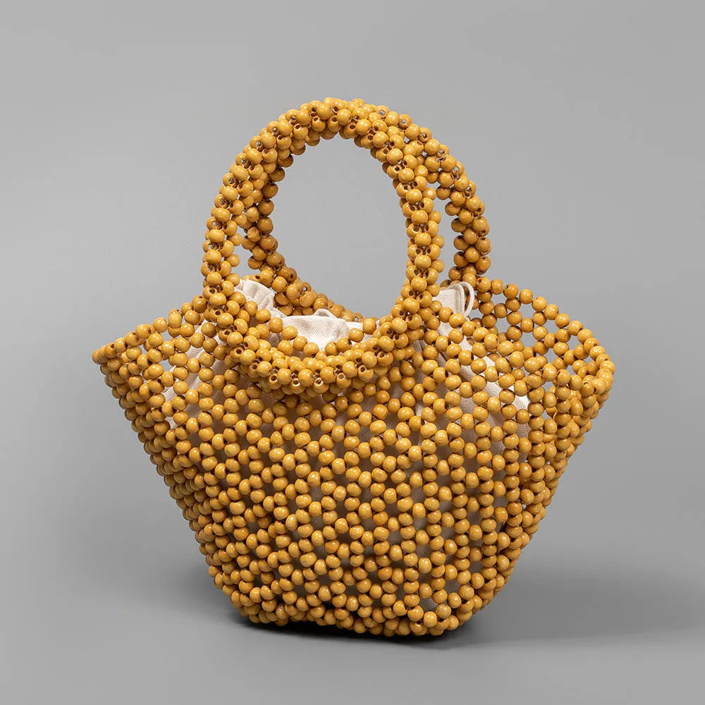 Hand-woven maple wood beach bag with wooden beads in dumpling shape.