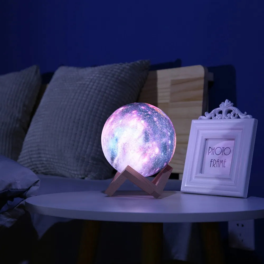 3D-printed lunar night light with LED colours, remote control, and touch sensor on wooden table