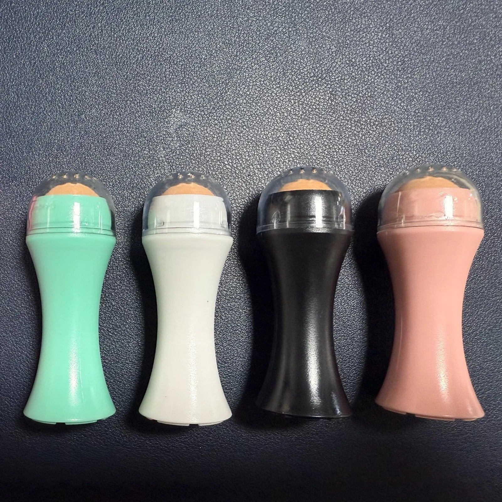Volcanic Portable Roller in black, green, pink, or white for oily skin control with real volcanic stone