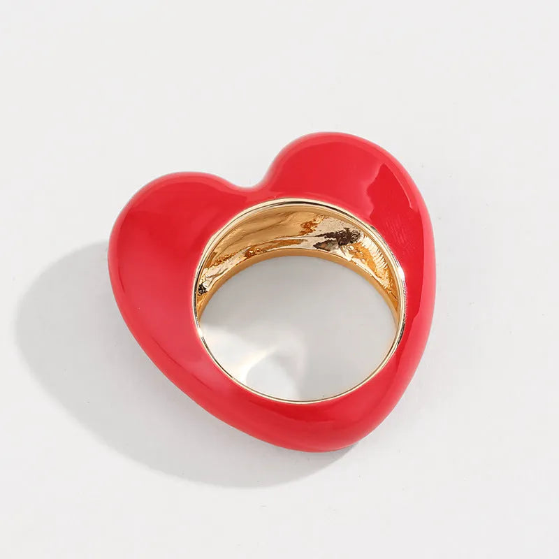 Three-dimensional heart-shaped enamel ring in black, pink, purple, or red colour, made from zinc alloy, sized 17 or 18.