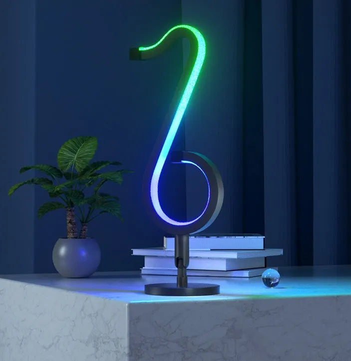 Black aluminium and iron APP-controlled LED atmosphere light with remote, showing 180-degree rotation on a desk.
