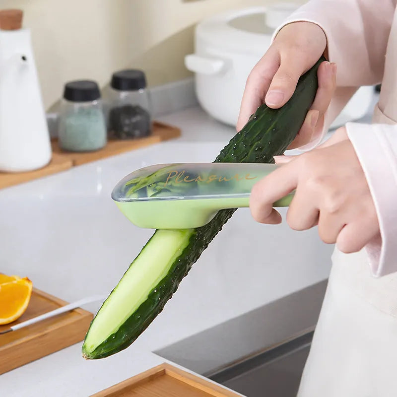 Green kitchen peeler with storage tube and stainless steel blade for fruit and vegetables