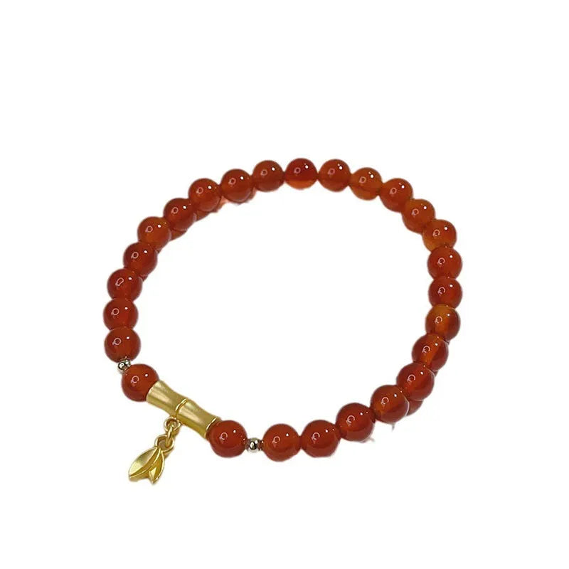 Women's handcrafted red agate bracelet with Chinese dragon design and lucky charm elements