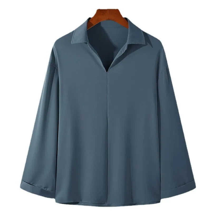 Men's loose fit long sleeve casual business shirt in a solid colour on a hanger