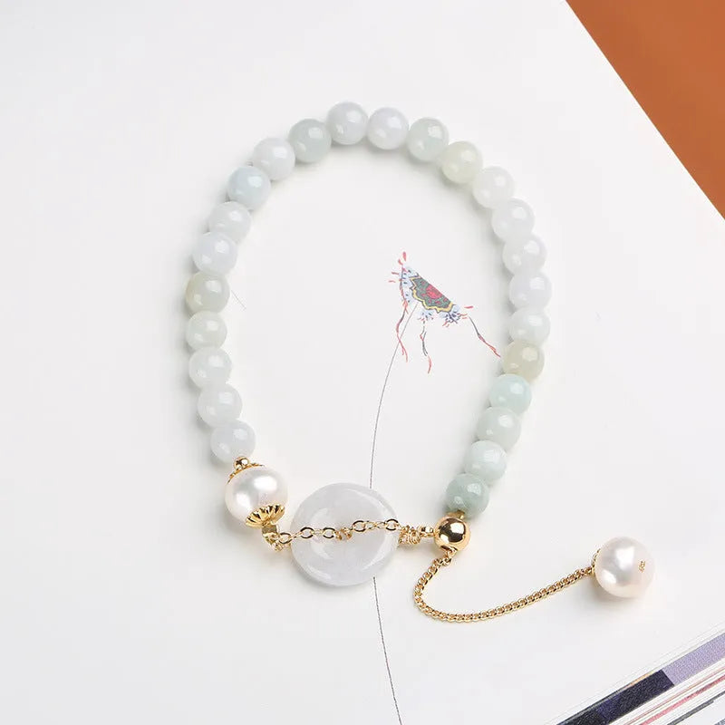 Handcrafted jade pearl bracelet with adjustable peace buckle closure and geometric design elements