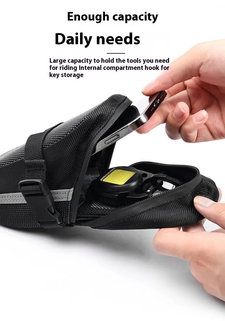 Black cycling quick release saddle bag with polyester construction mounted under bicycle saddle