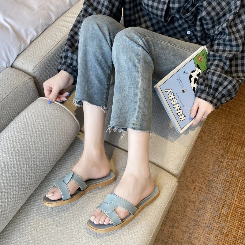Women's PVC cross strap toe ring flip flops in light blue on a white background.