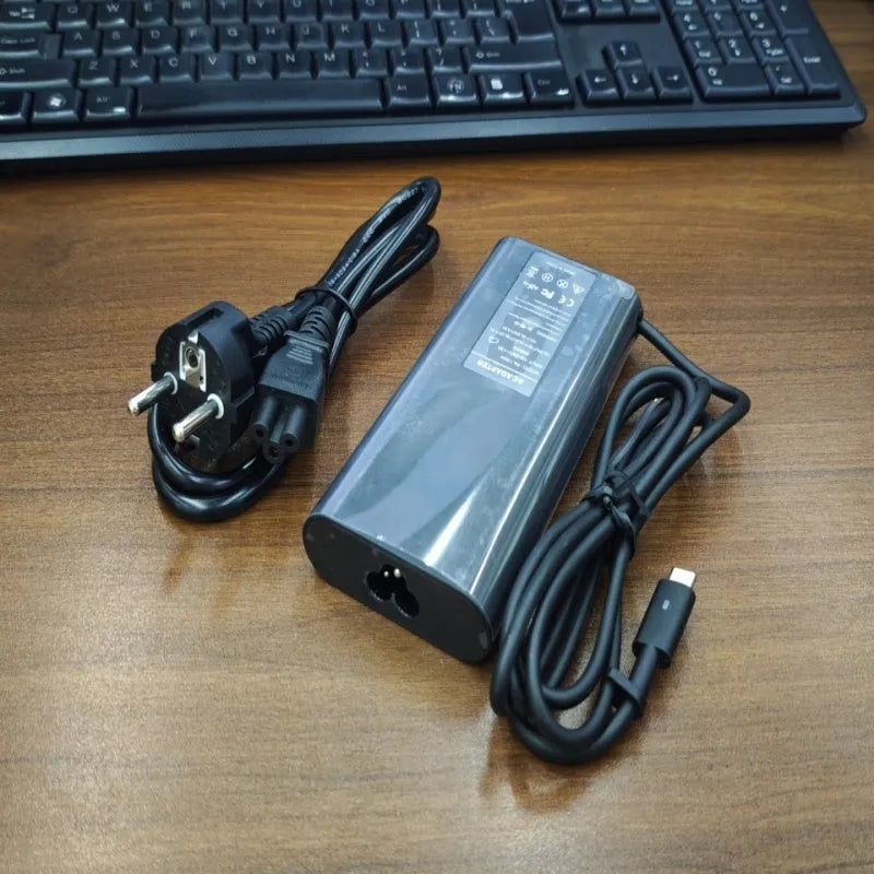 Black 65W USB Type-C laptop power adapter with international travel plug set