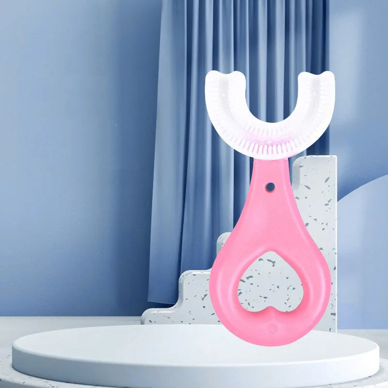 Children's U-shaped toothbrush in soft rubber for milk teeth cleaning, shown in pink and blue colours