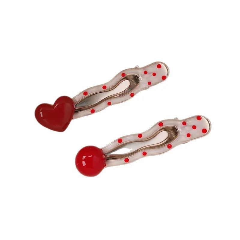 Red three-dimensional love heart-shaped hair barrette with retro dots and a willow leaf design.