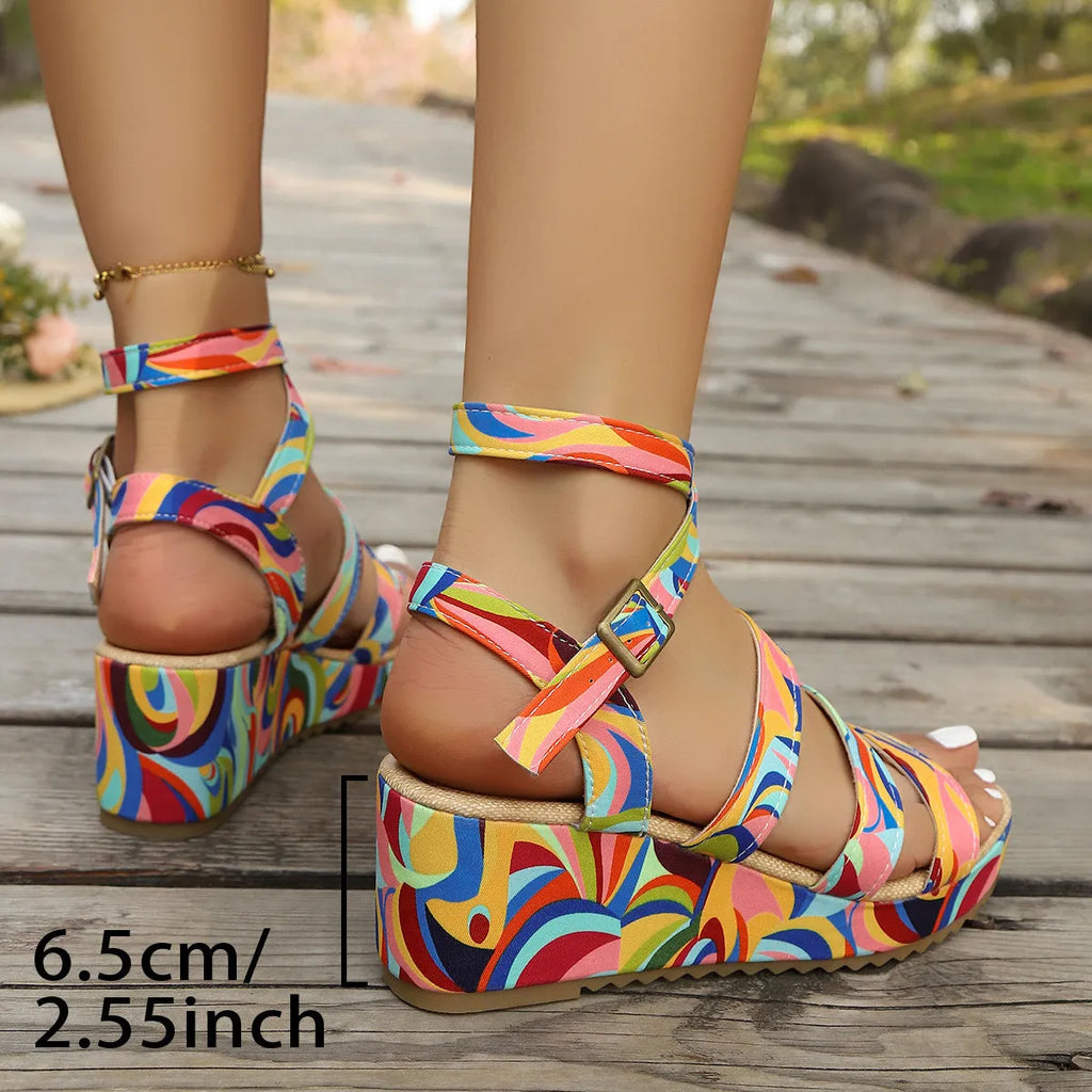 Women's light brown buckle wedge sandals with fish mouth toe and rubber sole on a white background.
