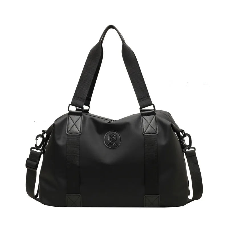 Large black waterproof Oxford cloth travel rucksack with multiple compartments shown on a grey background.