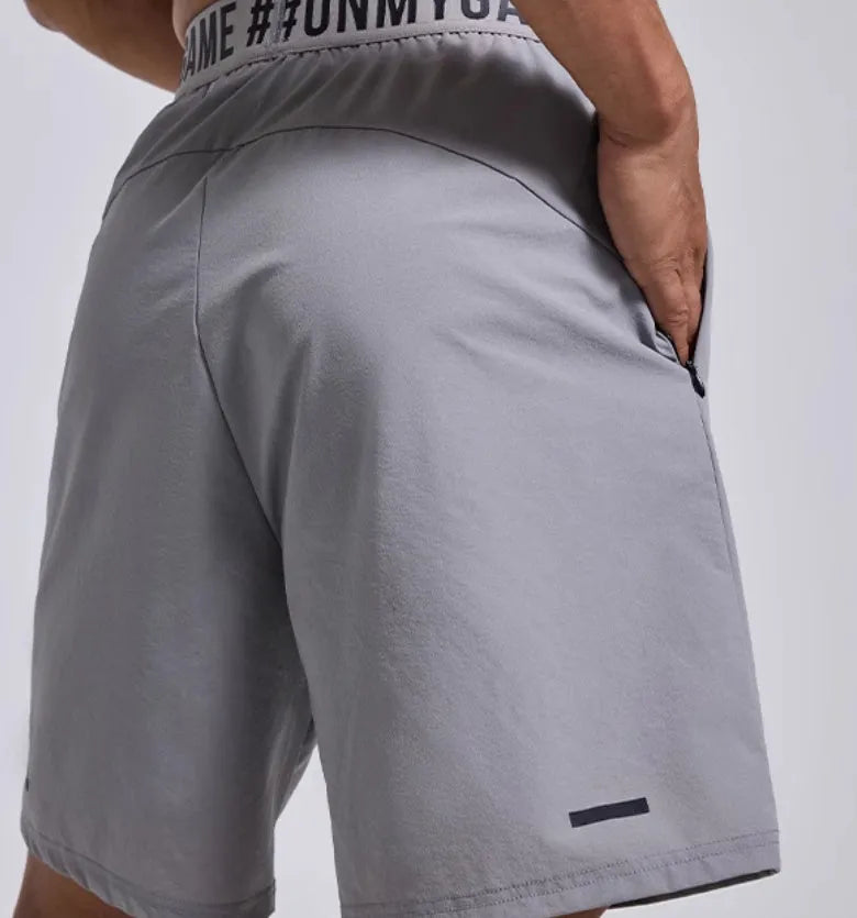 Men's loose black sports shorts with cropped design and elastic waist for workouts