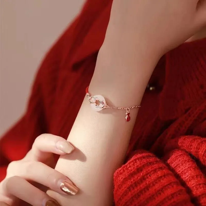 Women's red rope festive koi bracelet with peace buckle fastening and fishtail detailing