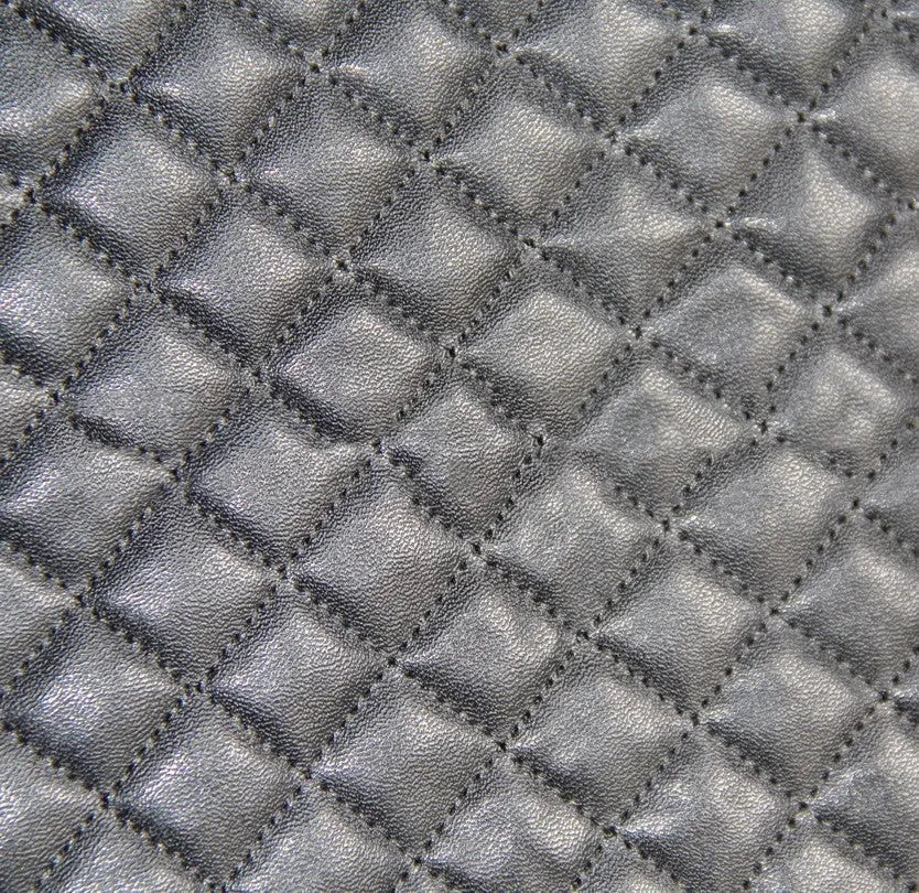 Black quilted automotive seat cover with PU and polyester fabric, showing sponge layer and plastic hooks